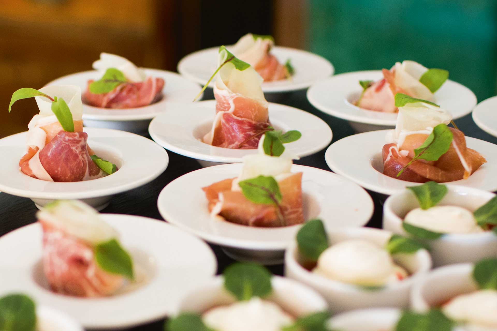 Plates of ham laid out for a large hotel conference