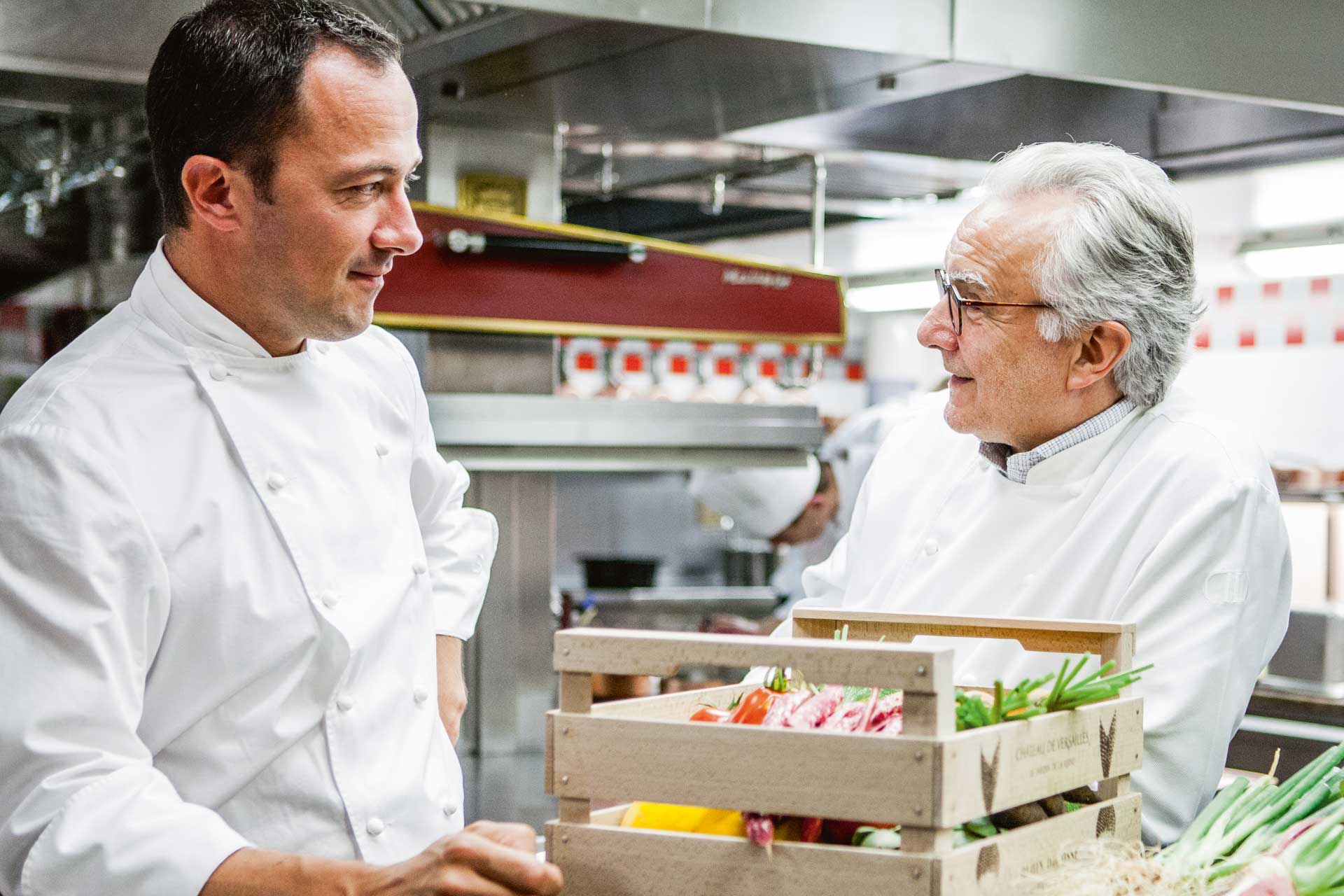 Michelin-starred chefs Romain Meder and Alain Ducasse in the kitchen